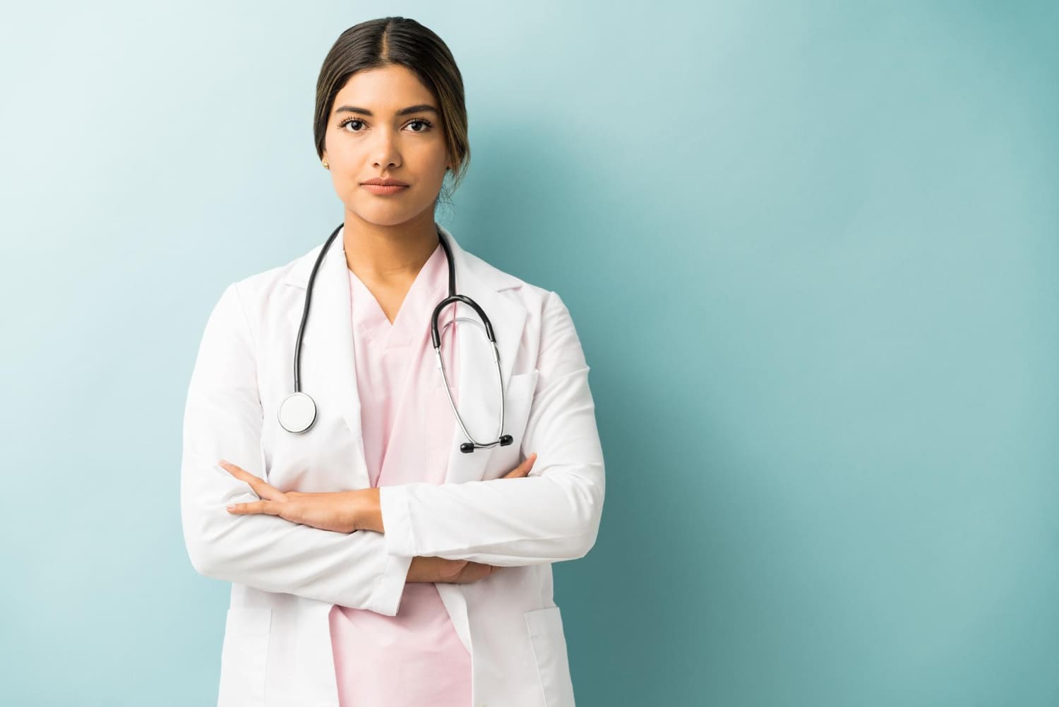 attractive-medical-professional-uniform-standing-with-arms-crossed-against-isolated-background(1)